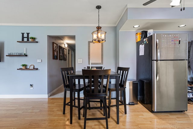 405 N Vorcey St, Tolono, IL 61880 - dining space featuring light wood-type flooring, ornamental molding, and a ceiling fan