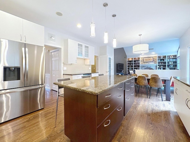 566 Primrose Ln, Crystal Lake, IL 60014 - kitchen featuring appliances with stainless steel finishes, dark wood-style flooring, a center island, white cabinetry, and glass insert cabinets