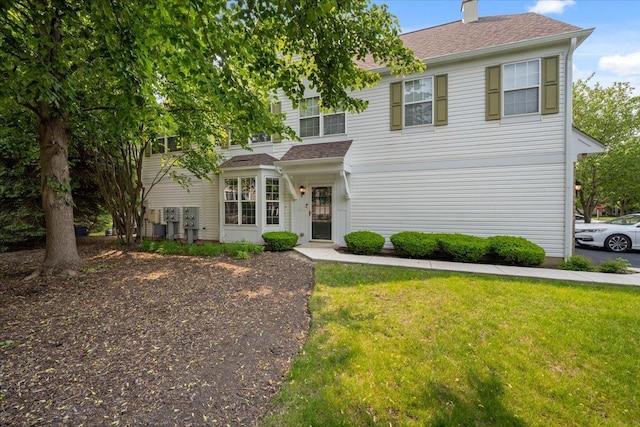 2936 Stonewater Dr Unit 2936, Naperville, IL 60564 - view of front of property with a front lawn, a chimney, and a shingled roof