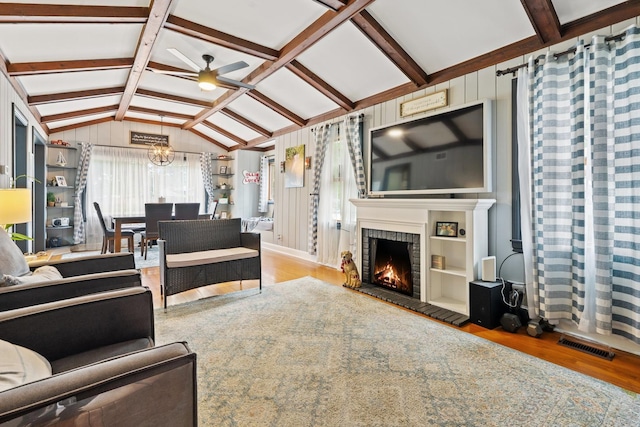 2250 Corona Rd, Waukegan, IL 60087 - living room with wood finished floors, ceiling fan, a brick fireplace, and a chandelier