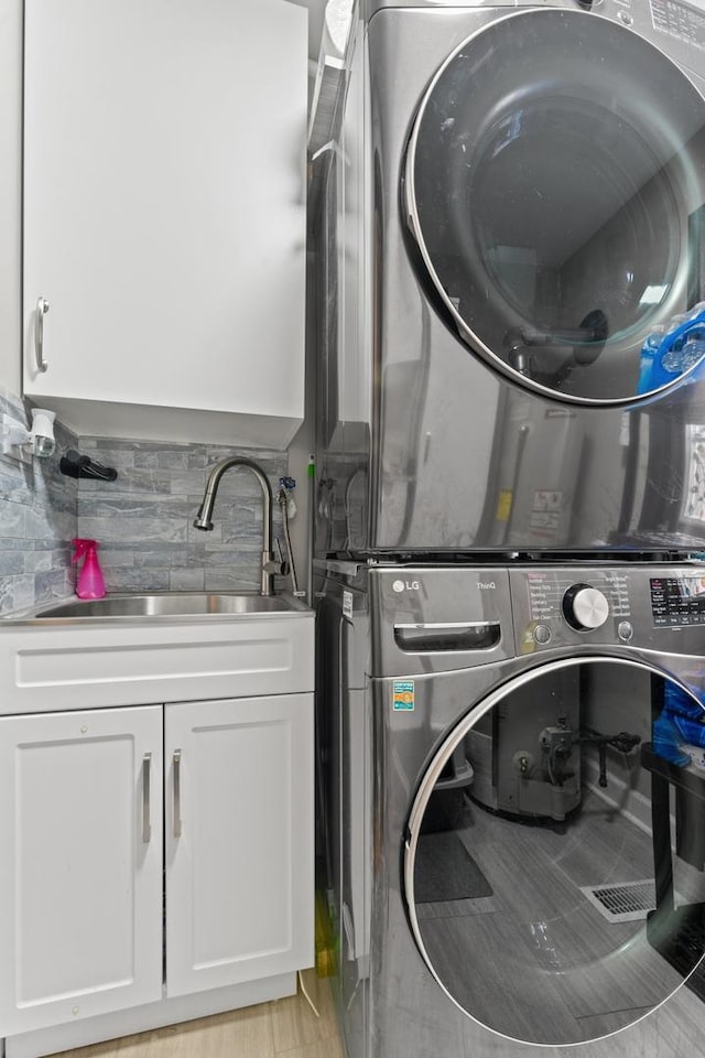 2250 Corona Rd, Waukegan, IL 60087 - washroom with stacked washer and clothes dryer and cabinet space