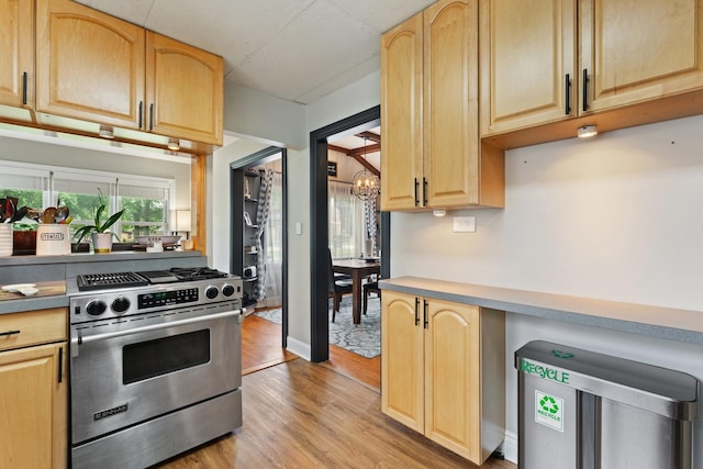 2250 Corona Rd, Waukegan, IL 60087 - kitchen featuring stainless steel range with gas cooktop, a chandelier, and light brown cabinetry