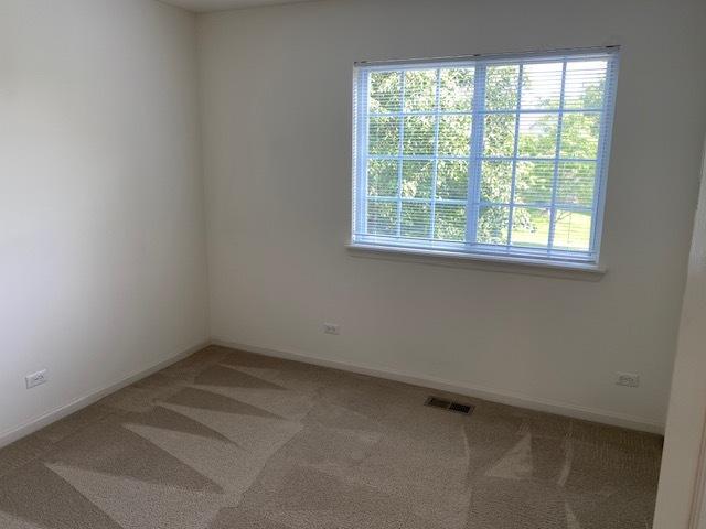1830 Maureen Dr, Hoffman Estates, IL 60192 - carpeted empty room with healthy amount of natural light