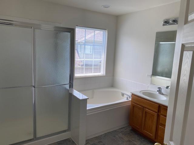 1830 Maureen Dr, Hoffman Estates, IL 60192 - bathroom featuring vanity, a garden tub, and a shower stall