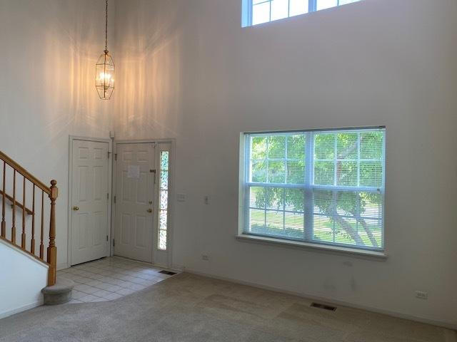 1830 Maureen Dr, Hoffman Estates, IL 60192 - foyer entrance with a towering ceiling, carpet floors, and stairway