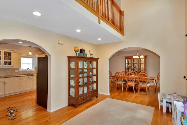352 Rye Rd, Mundelein, IL 60060 - dining area featuring light wood-style flooring, arched walkways, and recessed lighting