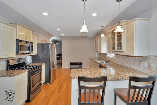 352 Rye Rd, Mundelein, IL 60060 - kitchen with stainless steel appliances, a peninsula, light stone countertops, glass insert cabinets, and recessed lighting
