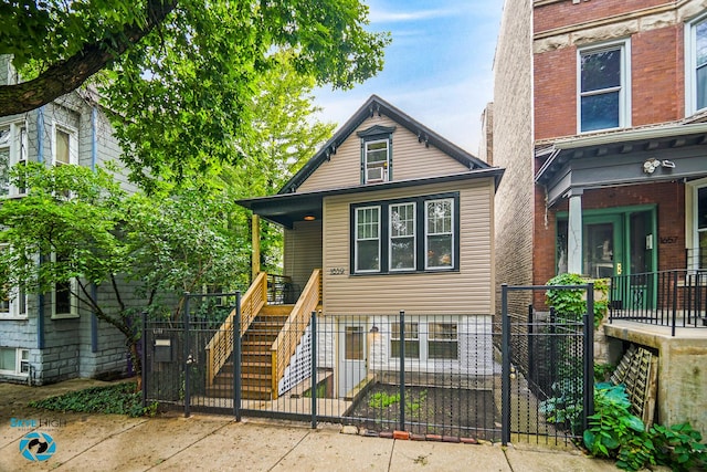 1659 N Francisco Ave, Chicago, IL 60647 - view of front of house featuring a fenced front yard, stairway, covered porch, and a gate