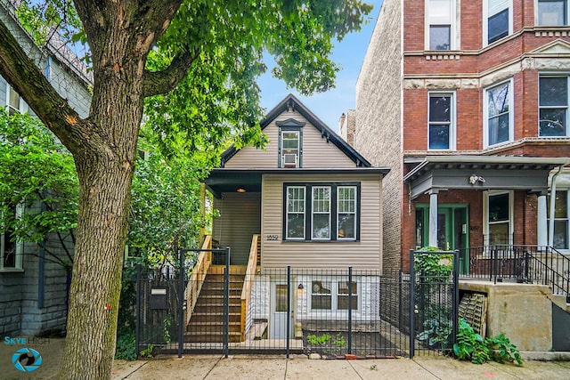1659 N Francisco Ave, Chicago, IL 60647 - view of front of property with a fenced front yard, a porch, stairs, a gate, and brick siding