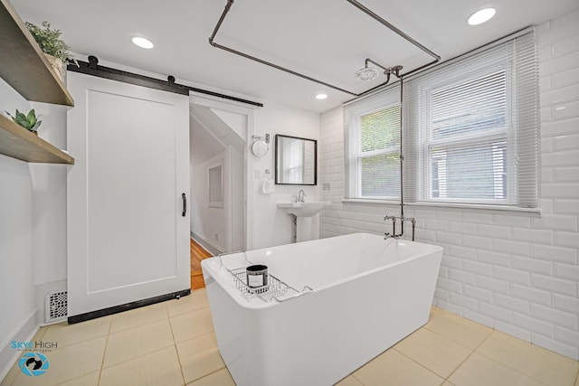 1659 N Francisco Ave, Chicago, IL 60647 - bathroom featuring a freestanding bath, tile walls, tile patterned flooring, and recessed lighting