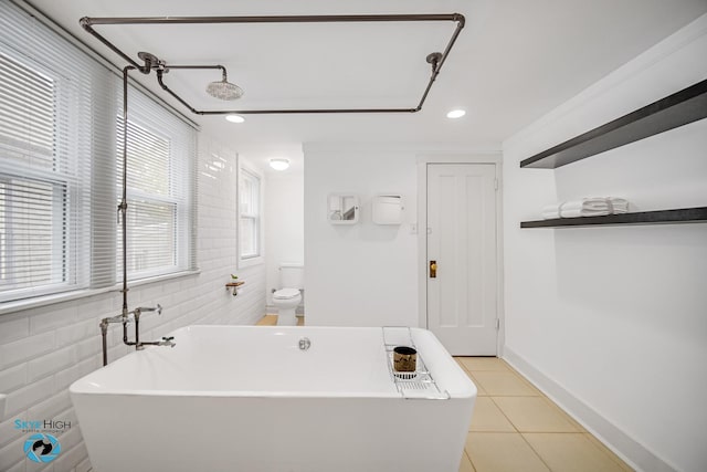 1659 N Francisco Ave, Chicago, IL 60647 - bathroom featuring tile patterned floors, a freestanding bath, tile walls, and recessed lighting