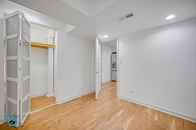 1659 N Francisco Ave, Chicago, IL 60647 - unfurnished bedroom featuring fridge with ice dispenser, light wood-style floors, recessed lighting, and a closet