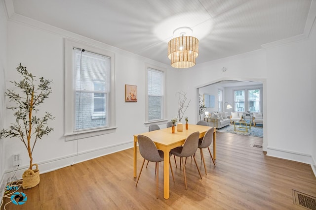 1659 N Francisco Ave, Chicago, IL 60647 - dining space featuring light wood-style floors, a chandelier, and ornamental molding