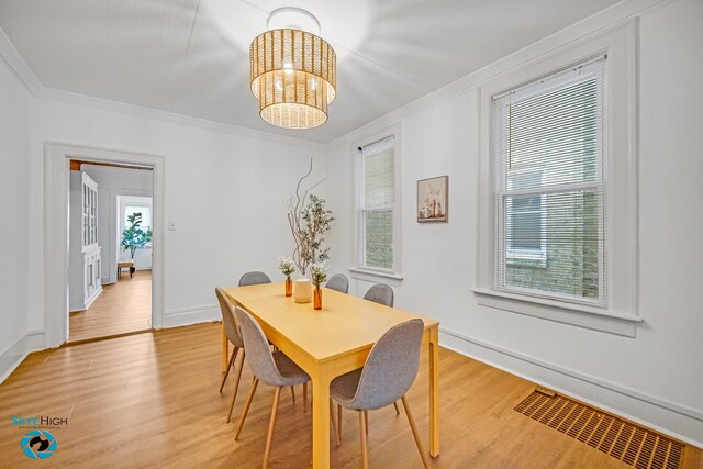 1659 N Francisco Ave, Chicago, IL 60647 - dining room featuring a chandelier, ornamental molding, and light wood-type flooring