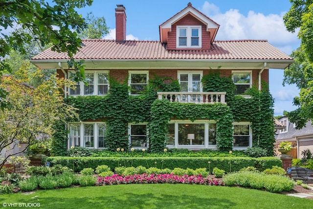 938 Edgemere Ct, Evanston, IL 60202 - rear view of property with a tiled roof, a chimney, a lawn, and brick siding