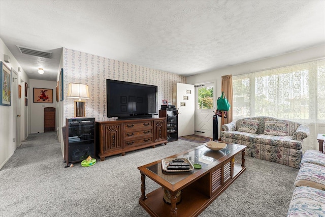1356 Briarcliff Dr, Rantoul, IL 61866 - living area with wallpapered walls, carpet, and a textured ceiling