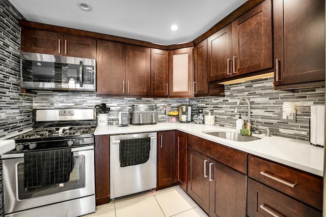 9819 Nottingham Ave Unit 106, Chicago Ridge, IL 60415 - kitchen featuring stainless steel appliances, tasteful backsplash, light countertops, light tile patterned floors, and dark brown cabinets