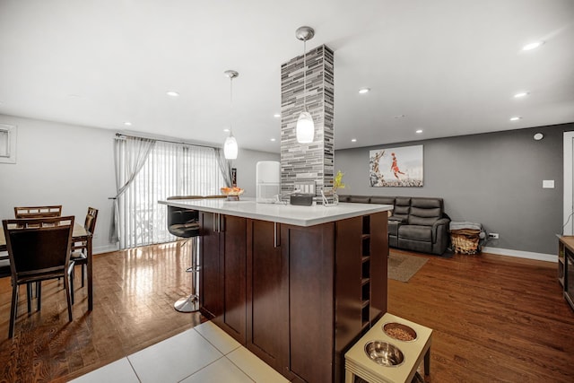 9819 Nottingham Ave Unit 106, Chicago Ridge, IL 60415 - kitchen with light countertops, a center island, recessed lighting, dark brown cabinets, and hanging light fixtures