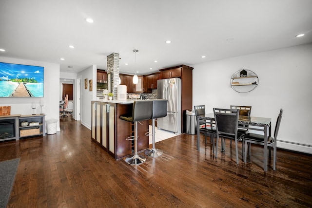 9819 Nottingham Ave Unit 106, Chicago Ridge, IL 60415 - kitchen with freestanding refrigerator, dark wood-style flooring, light countertops, a breakfast bar, and recessed lighting