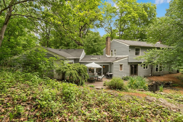 36W525 Wild Rose Rd, Saint Charles, IL 60174 - back of property with a chimney and a patio