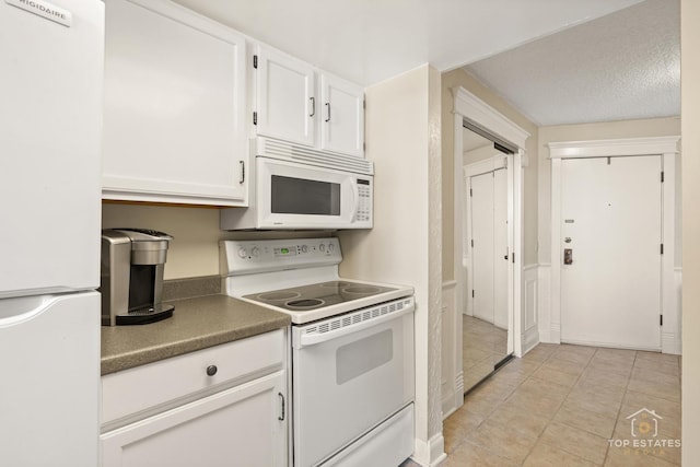 1 Renaissance Pl Unit 1121, Palatine, IL 60067 - kitchen with white appliances, white cabinets, light tile patterned flooring, and dark countertops