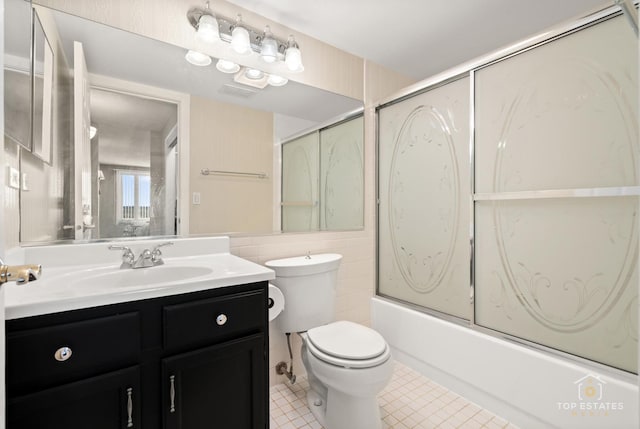 1 Renaissance Pl Unit 1121, Palatine, IL 60067 - bathroom featuring bath / shower combo with glass door, vanity, tile patterned floors, and tile walls