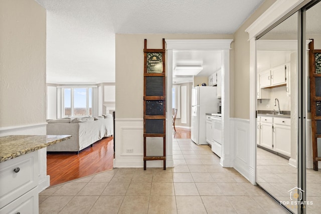 1 Renaissance Pl Unit 1121, Palatine, IL 60067 - hall featuring wainscoting, light tile patterned floors, and a decorative wall