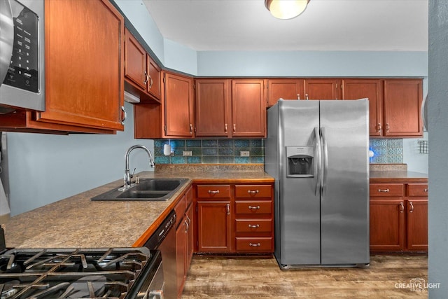 1005 Georgian Pl Unit 1005, Bartlett, IL 60103 - kitchen featuring stainless steel appliances, wood finished floors, decorative backsplash, and brown cabinetry