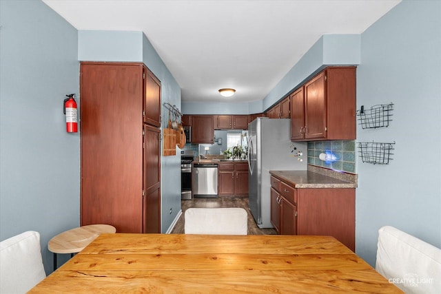 1005 Georgian Pl Unit 1005, Bartlett, IL 60103 - kitchen featuring appliances with stainless steel finishes, decorative backsplash, and wood finished floors
