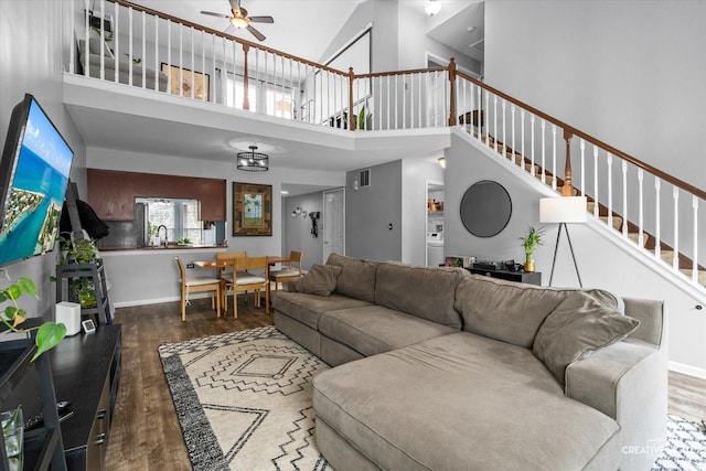 1005 Georgian Pl Unit 1005, Bartlett, IL 60103 - living room featuring ceiling fan, wood finished floors, a towering ceiling, and stairs