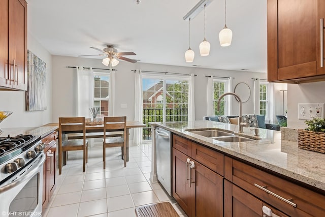 926 Bromley Pl, Northbrook, IL 60062 - kitchen featuring stainless steel appliances, brown cabinets, ceiling fan, hanging light fixtures, and light stone counters