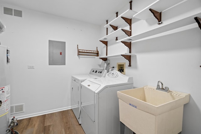 1401 Clove Ct Unit D, Mount Prospect, IL 60056 - washroom featuring electric panel, washer and clothes dryer, wood finished floors, and gas water heater