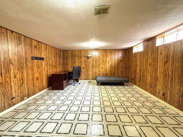 8664 Gregory Ln Unit E, Des Plaines, IL 60016 - unfurnished office with a textured ceiling, wooden walls, and light flooring
