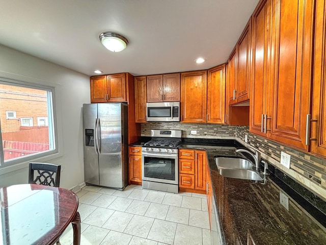 8664 Gregory Ln Unit E, Des Plaines, IL 60016 - kitchen with stainless steel appliances, brown cabinetry, decorative backsplash, dark stone counters, and recessed lighting