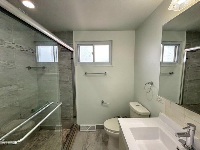 8664 Gregory Ln Unit E, Des Plaines, IL 60016 - bathroom featuring a stall shower, marble finish flooring, vanity, and recessed lighting