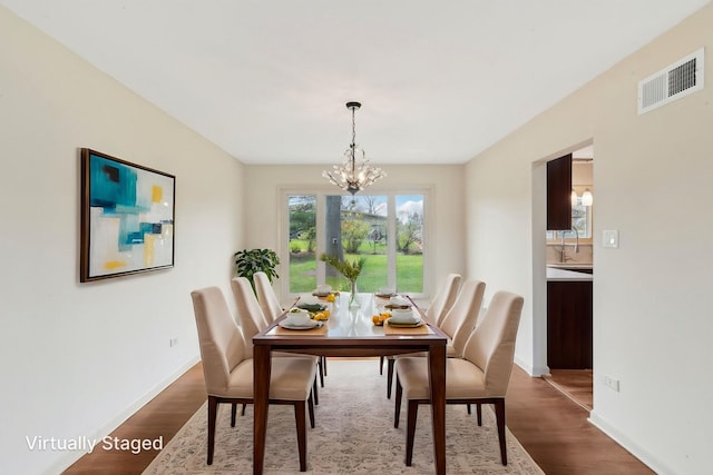 6709 W Menominee Pkwy, Palos Heights, IL 60463 - dining area with a chandelier and dark wood-type flooring
