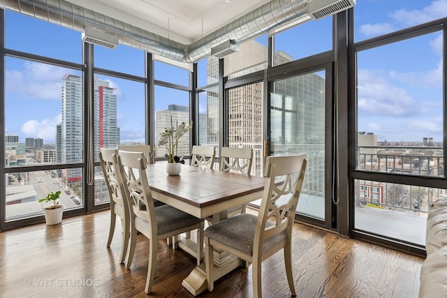 212 E Cullerton St Unit Ph06, Chicago, IL 60616 - dining area featuring a view of skyline, expansive windows, and wood finished floors