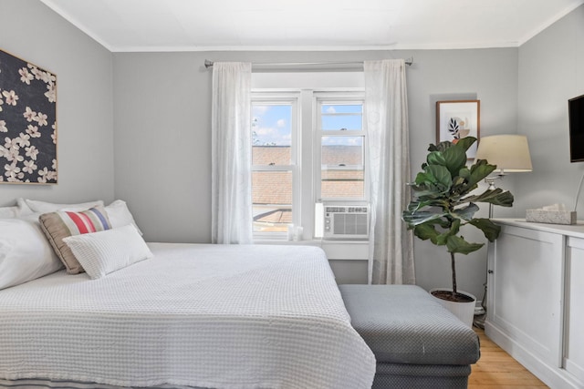 2119 N Karlov Ave, Chicago, IL 60639 - bedroom with light wood-type flooring, cooling unit, and crown molding