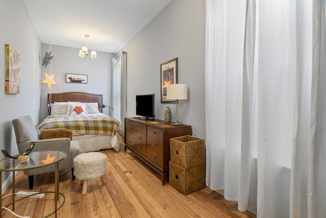 2119 N Karlov Ave, Chicago, IL 60639 - bedroom with light wood-type flooring and a chandelier