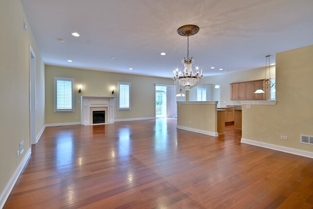 121 Rose Dr, Bloomingdale, IL 60108 - unfurnished living room featuring a chandelier, a fireplace, dark wood-style floors, and recessed lighting