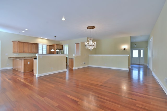 121 Rose Dr, Bloomingdale, IL 60108 - unfurnished living room with a chandelier, dark wood-style flooring, and recessed lighting