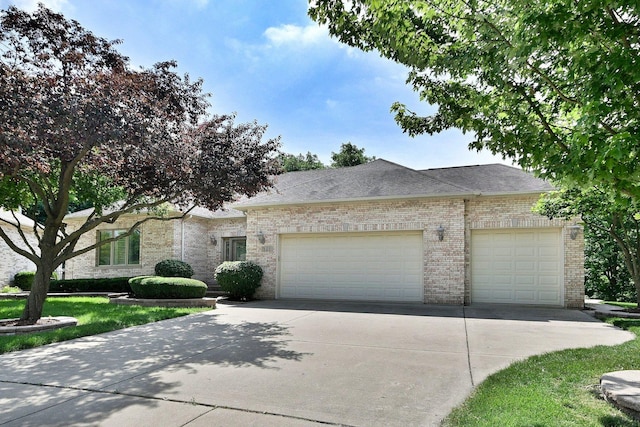 121 Rose Dr, Bloomingdale, IL 60108 - view of front facade featuring brick siding, a garage, concrete driveway, and a shingled roof