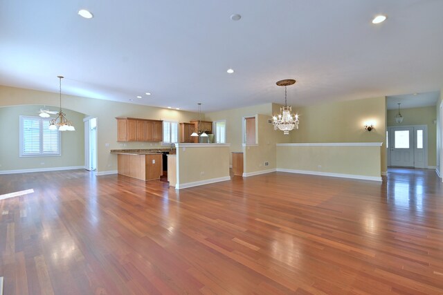 121 Rose Dr, Bloomingdale, IL 60108 - unfurnished living room with a chandelier, dark wood-style floors, recessed lighting, and arched walkways