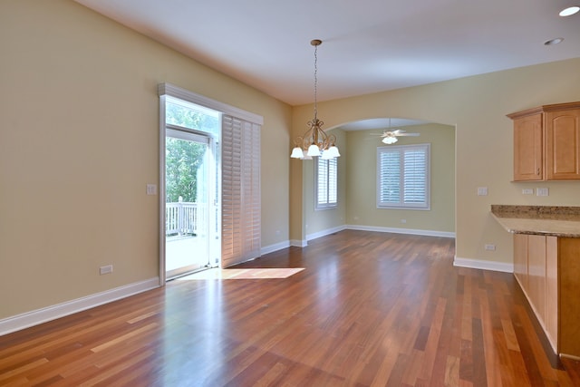 121 Rose Dr, Bloomingdale, IL 60108 - unfurnished dining area with healthy amount of natural light, a chandelier, wood finished floors, and ceiling fan