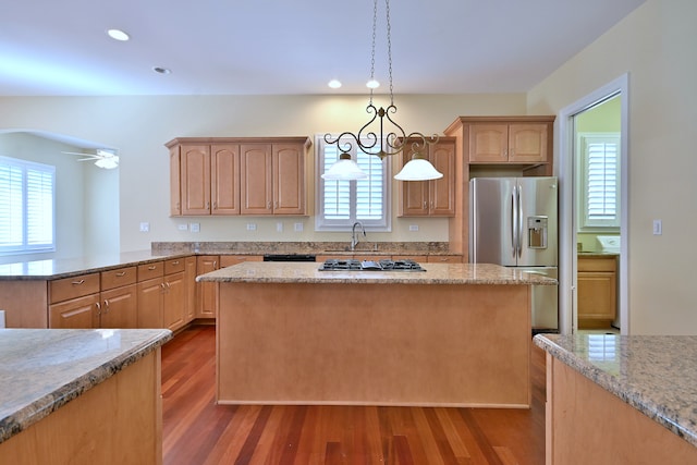 121 Rose Dr, Bloomingdale, IL 60108 - kitchen featuring stainless steel appliances, dark wood finished floors, light stone countertops, a kitchen island, and recessed lighting