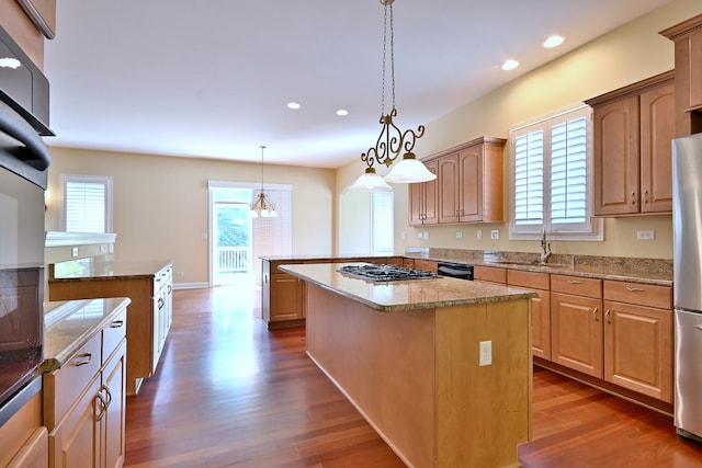121 Rose Dr, Bloomingdale, IL 60108 - kitchen featuring a kitchen island, dark wood finished floors, recessed lighting, appliances with stainless steel finishes, and light stone countertops
