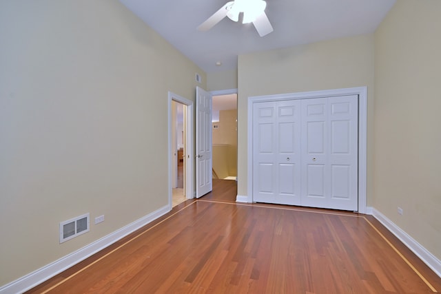 121 Rose Dr, Bloomingdale, IL 60108 - unfurnished bedroom featuring wood finished floors, a closet, and a ceiling fan