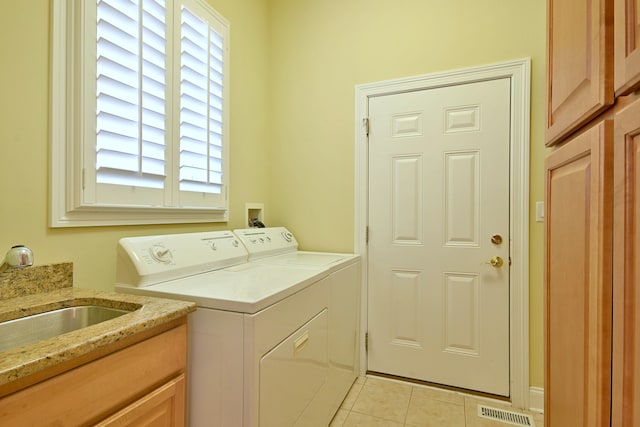 121 Rose Dr, Bloomingdale, IL 60108 - washroom featuring washer and dryer, light tile patterned floors, plenty of natural light, and cabinet space
