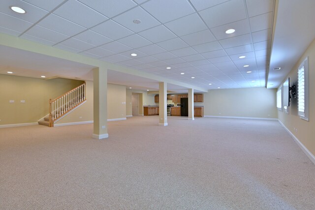 121 Rose Dr, Bloomingdale, IL 60108 - below grade area with freestanding refrigerator, stairs, light colored carpet, and recessed lighting