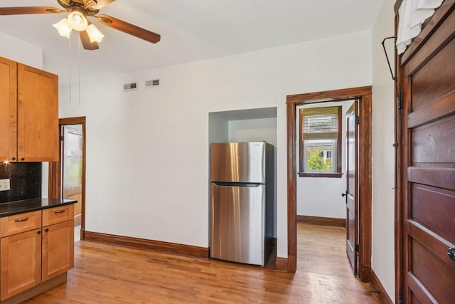 2638 W Rice St Unit 2S, Chicago, IL 60622 - kitchen featuring freestanding refrigerator, light wood-style floors, a ceiling fan, backsplash, and brown cabinets